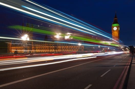 Big Ben, one of the most prominent symbols of both London and England, as shown at night along with the lights of the cars passing by