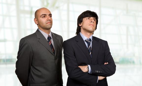 two young business men thinking, at the office