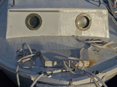 bow of an old fishing boat with round windows         