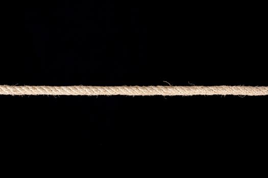 Twisted manila rope isolated on black background
