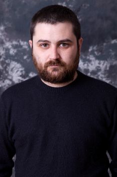 young casual man portrait on a dark background