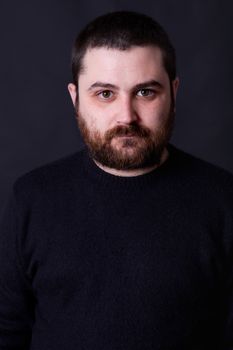 young casual man portrait on a black background