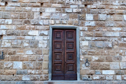 wooden door on stone wall