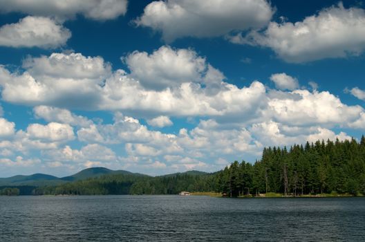 Mountain lake with cloudy sky