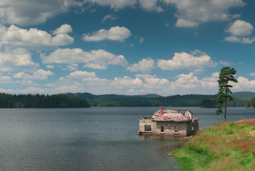 Mountain lake with flood house