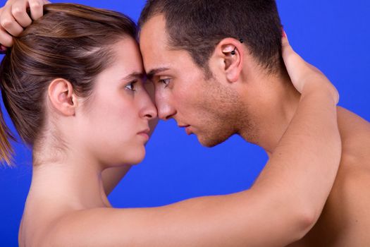 young couple together portrait on blue background