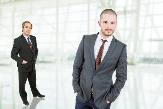 two business men standing at the office