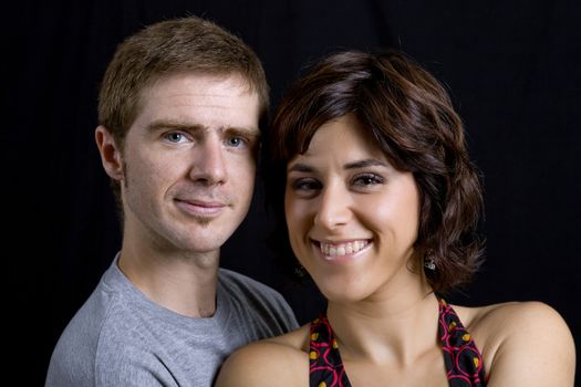 young couple together portrait on black background