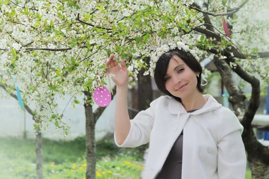 Sensual woman with wreath among spring garden