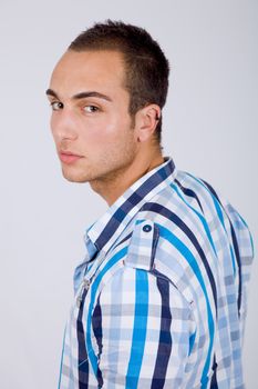 young sensual casual man portrait on a grey background