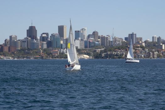 Sydney, Australia-March 13th 2013:: Yachts sailing in Sydney Harbour with the CBD in the background. Sailing is a very popular pastime in Sydney.