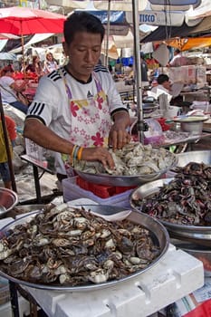 Bangkok, Thailand-December 7th 2011: A vendor prepares seafood on a stall in Chinatown. Chinatown is one of the oldest areas in Bangkok.