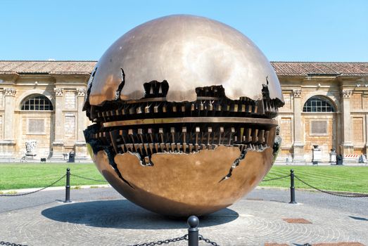 Sculpture within sphere in Courtyard of the Pinecone at Vatican Museums, created in 1990 by Italian sculptor Arnoldo Pomodoro