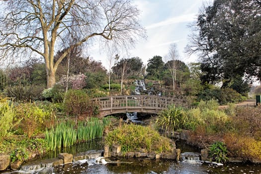 Small bridge over a chanel in a spring park