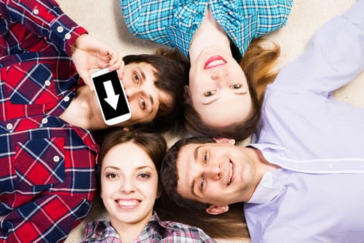 four young people are together, the young man pressed his lips to the phone