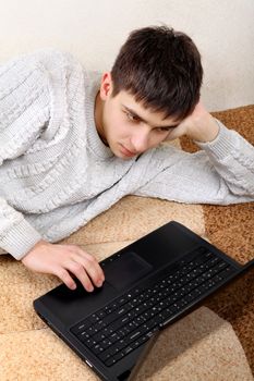 Teenager with Laptop on the Sofa