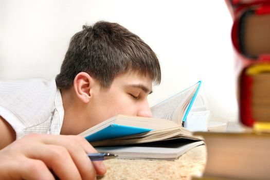 Tired Teenager sleeping on the Book