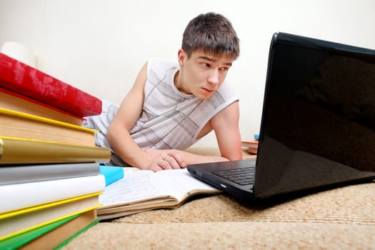 Annoyed Teenager doing Homework at the Home