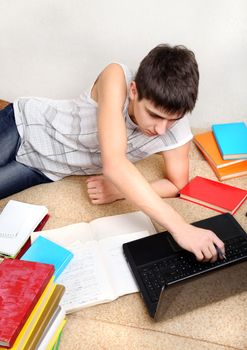 Teenager doing Homework on the Sofa at the Home