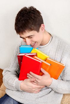 Cheerful Teenager with a Books at the Home