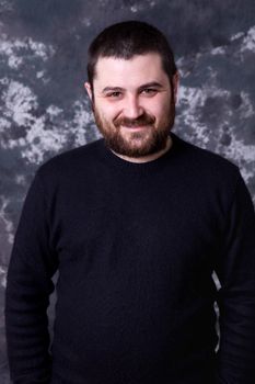 young casual man portrait on a dark background