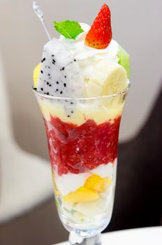 Ice cream and fruit in a cup.