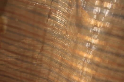 Background image of a formless abstraction with golden highlights and curves