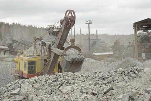 power hydraulic digger working in quarry, caterpillar