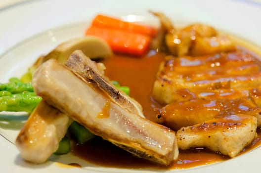 pork steak in a white plate.