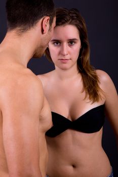 young couple together portrait on black background