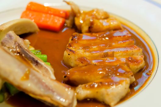 pork steak in a white plate.