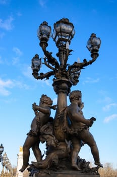 Light pole at the bridge Alexandre III in Paris, France.