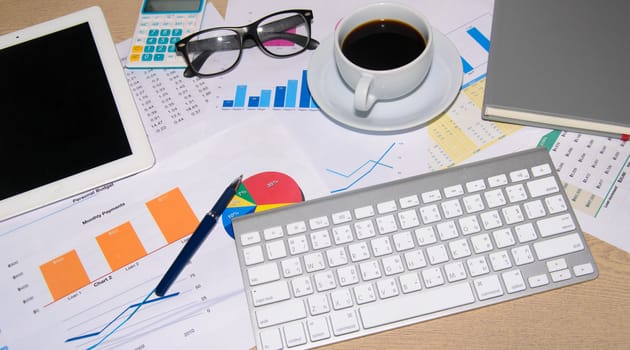 Business documents and keyboard placed on desks.