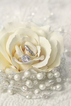 Wedding rings in cream rose flower