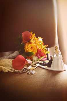 Cake figurines with bouquet on velvet chair