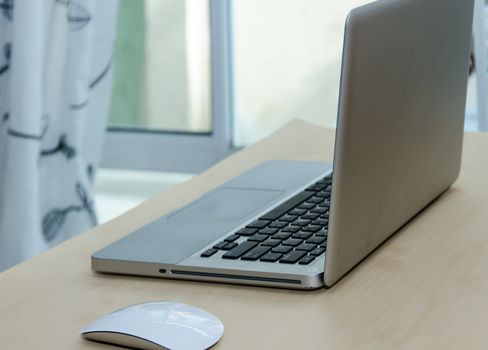 Notebook computer with the mouse and placed on the desks.