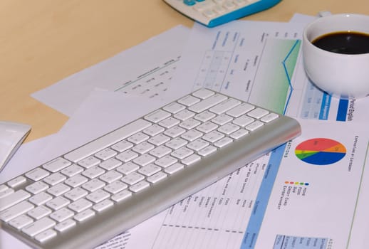 Business documents and keyboard placed on desks.