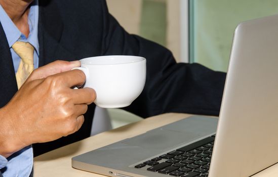 A cup of coffee with a computer