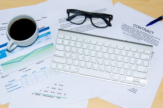 Business documents and keyboard placed on desks.