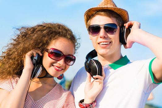 young couple standing on the road, having fun with friends