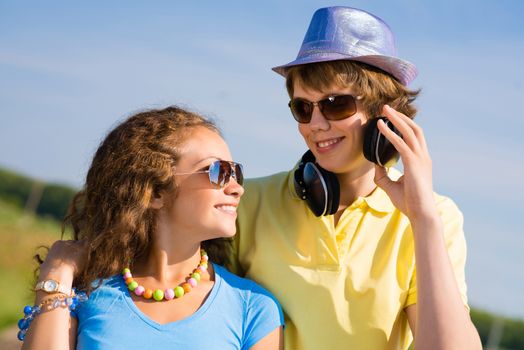 young couple standing on the road, having fun with friends