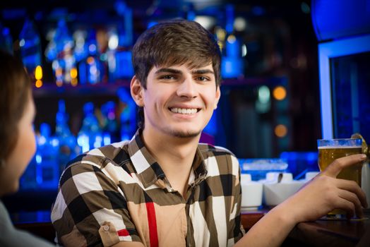 portrait of a young man at the bar, fun nightlife