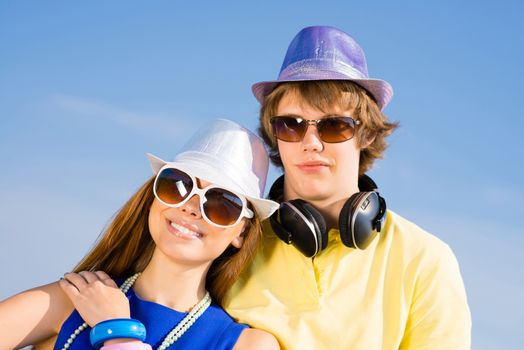 young couple standing on the road, having fun with friends