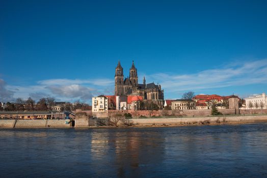 Magnificent Cathedral of Magdeburg at river Elbe with blue sky, Germany, 2014