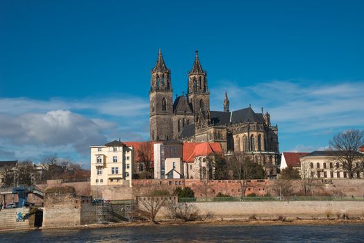 Magnificent Cathedral of Magdeburg at river Elbe with blue sky, Germany