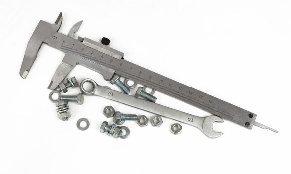 Slide caliper, spanner, nuts and bolts. Isolated on white background