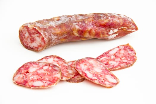 Salami with slices on white background