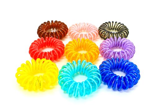 Spiral colorful elastic hair ties used on a white background.