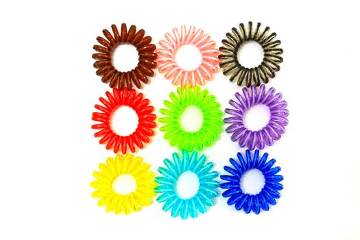 Spiral colorful elastic hair ties used on a white background.