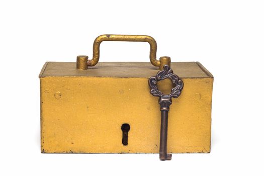 The golden old trunk with the key isolated on a white background 